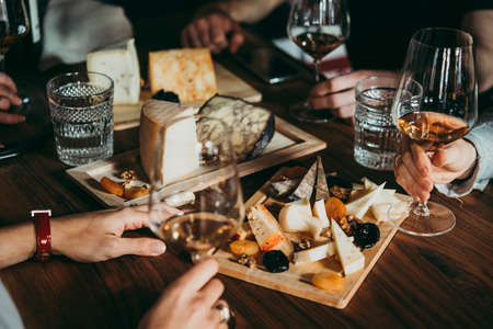 Wine and cheese served for a friendly party in a bar or a restaurant.の写真素材