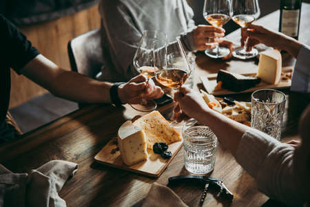Wine and cheese served for a friendly party in a bar or a restaurant.の写真素材