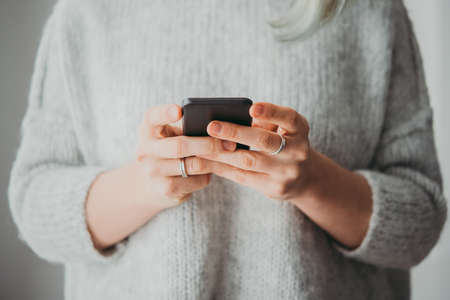 Young woman holding her smartphoneの写真素材
