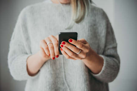 Young woman holding her smartphoneの写真素材