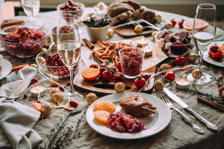 Healthy modern vegetable dishes and roasted turkey or duck. Dinner table, celebrating Christmas or New Year eve.の写真素材