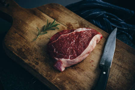 A piece of beef sirloin steak on a wooden boardの写真素材
