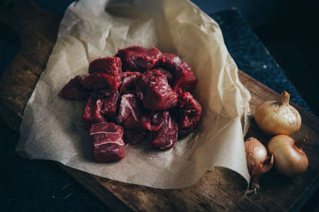 Pieces of beef cut and onions  ready for stewing.の写真素材