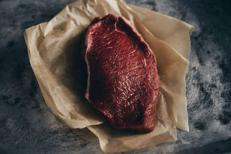 A piece of beef sirloin on a craft paperの写真素材