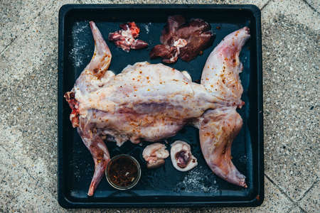 Rabbit whole round on a tray ready for baking.の写真素材