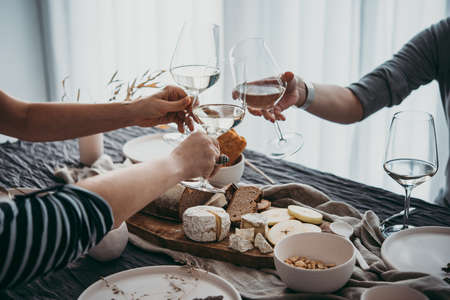 Glasses of white wine seen during a friendly party of a celebration.の写真素材