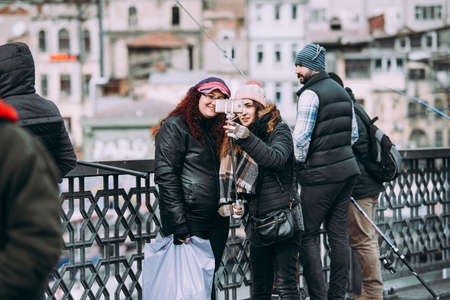 ISTANBUL, TURKEY - 29 JANUARY, 2017: Tourists take pictures at the Galata bridge in Istanbul, Turkey.のeditorial素材
