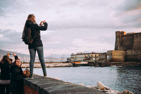 NAPLES, ITALY - 18 DECEMBER, 2017: People taking photos at the seaside in Naples, Campania, Italy.のeditorial素材