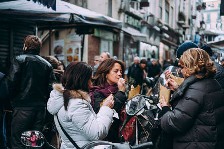 NAPLES, ITALY - 17 DECEMBER, 2017: People enjoy street food in Naples, Campania, Italy.のeditorial素材