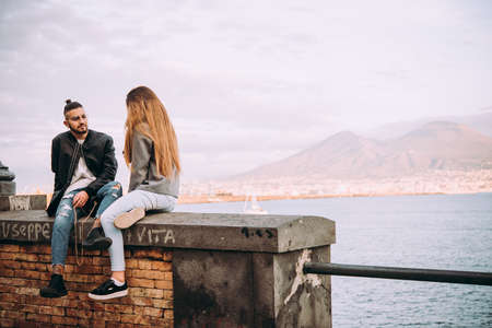 NAPLES, ITALY - 18 DECEMBER, 2017: A couple enjoys relaxing at the seaside in Naples, Campania, Italy.のeditorial素材