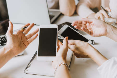 Sharing information from a mobile phone during discussion and creative process.の写真素材