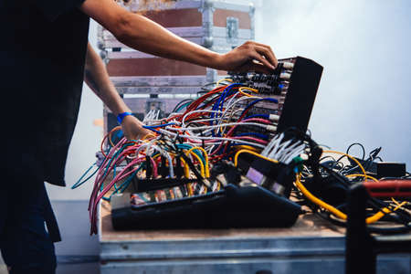 Musician performs on stage using modular synthesizers. Electronic music and professional music equipment concept.の写真素材