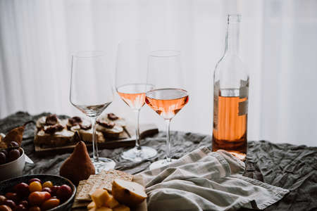Glasses and bottle of rose wine seen during a friendly party of a celebration.