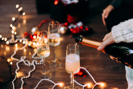 New year and Christmas celebration with champagne in front the Christmas tree.の写真素材