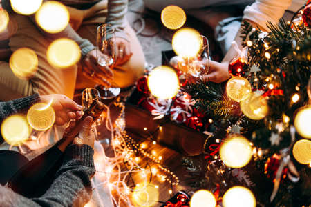 New year and Christmas celebration with champagne in front the Christmas tree.の写真素材