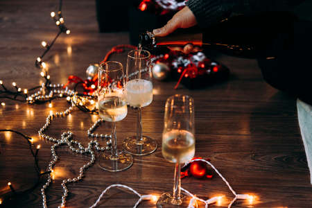 New year and Christmas celebration with champagne in front the Christmas tree.の写真素材