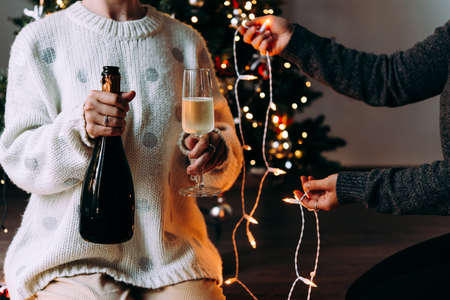 New year and Christmas celebration with champagne in front the Christmas tree.の写真素材