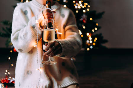 New year and Christmas celebration with champagne in front the Christmas tree.の写真素材