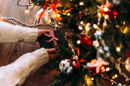 Hands holding a present box. Christmas and New Year celebration concept.の写真素材