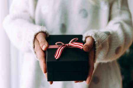 Hands holding a present box. Christmas and New Year celebration concept.の写真素材