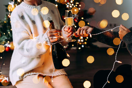 New year and Christmas celebration with champagne in front the Christmas tree.の写真素材