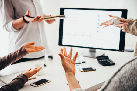 Young creative managers analyzing financial charts and graphs on a laptop. Successful teamwork and business brainstorm concept. Toned imageの写真素材