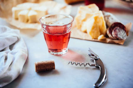 Mediterranean snack with a  glass of rose wine and different appetisers on the table.の写真素材