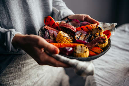 Serving a steak and grilled vegetable salad. Healthy home eating concept.の写真素材