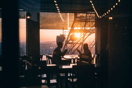 People enjoy the evening city view in one of the restaurants in Seoul, South Korea.
