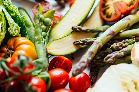 Different fresh vegetables and greens on the table before cooking. Healthy mediterranean eating concept.の写真素材