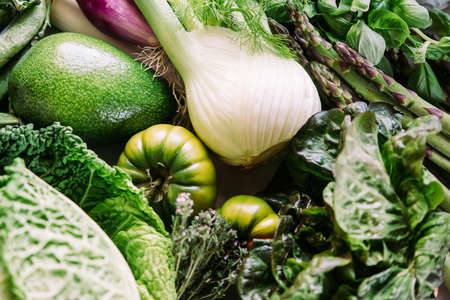 Different fresh vegetables and greens on the table before cooking. Healthy eating concept.の写真素材