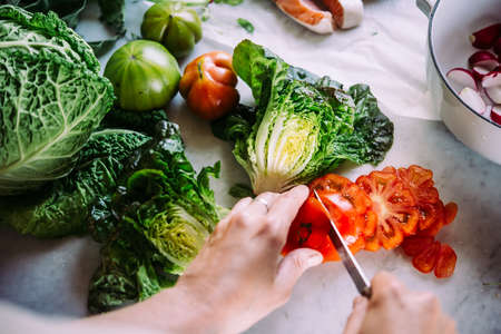 Making salad of cooking different vegetables and greens. Healthy eating concept.の写真素材