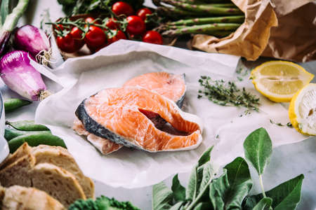 Salmon fish and different vegetables prepared for dinner cooking. Healthy eating concept.の写真素材