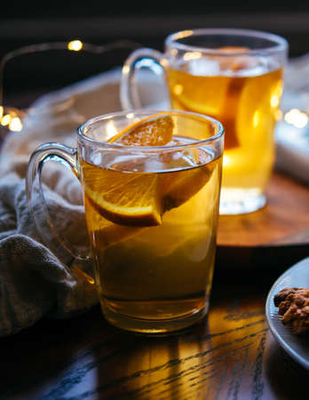 Hot beverages tea or mulled white wine served with gingerbread. Christmas celebration concept.