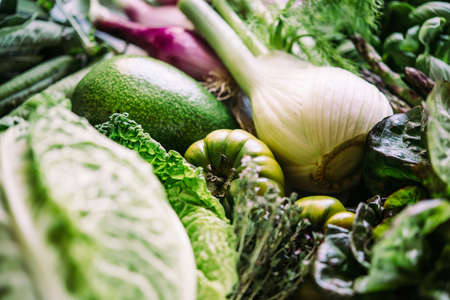 Different fresh vegetables and greens on the table before cooking. Healthy eating concept.の写真素材