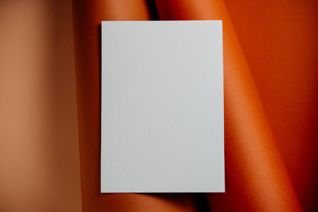 Stylish white blank paper mockup on a colorful background. Document and presentation stationery creator. Selective focus on paperの写真素材