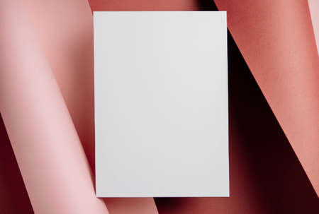 Stylish white blank paper mockup on a colorful background. Document and presentation stationery creator. Selective focus on paperの写真素材