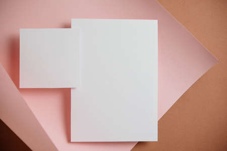 Stylish white blank paper mockup on a colorful background. Document and presentation stationery creator. Selective focus on paperの写真素材