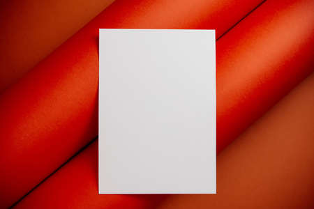 Stylish white blank paper mockup on a colorful background. Document and presentation stationery creator. Selective focus on paperの写真素材