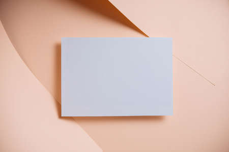 Stylish white blank paper mockup on a colorful background. Document and presentation stationery creator. Selective focus on paperの写真素材