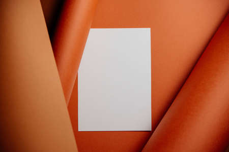 Stylish white blank paper mockup on a colorful background. Document and presentation stationery creator. Selective focus on paperの写真素材