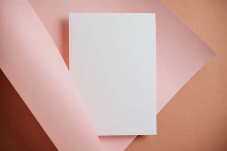 Stylish white blank paper mockup on a colorful background. Document and presentation stationery creator. Selective focus on paperの写真素材