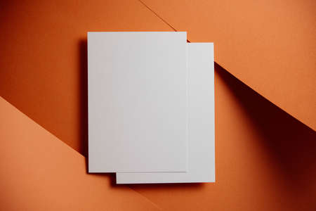 Stylish white blank paper mockup on a colorful background. Document and presentation stationery creator. Selective focus on paperの写真素材