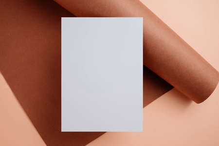 Stylish white blank paper mockup on a colorful background. Document and presentation stationery creator. Selective focus on paperの写真素材