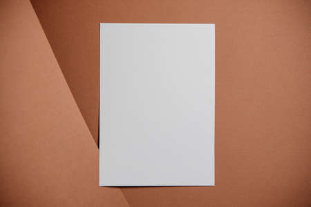 Stylish white blank paper mockup on a colorful background. Document and presentation stationery creator. Selective focus on paperの写真素材