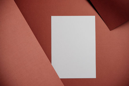 Stylish white blank paper mockup on a colorful background. Document and presentation stationery creator. Selective focus on paperの写真素材