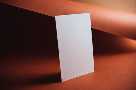 Stylish white blank paper mockup on a colorful background. Document and presentation stationery creator. Selective focus on paperの写真素材
