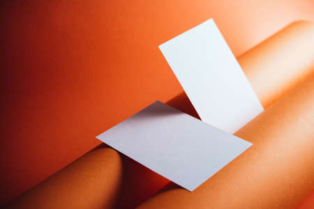 Stylish white blank paper mockup on a colorful background. Document and presentation stationery creator. Selective focus on paperの写真素材