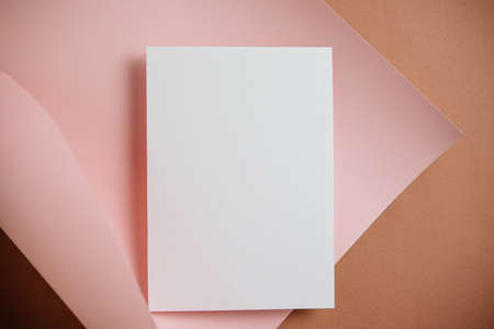 Stylish white blank paper mockup on a colorful background. Document and presentation stationery creator. Selective focus on paperの写真素材