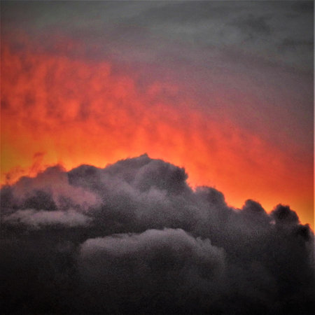 A processed square version of gray cloud yellow sky.の写真素材